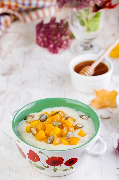 Healthy breakfast. Rice porridge with milk and pumpkin