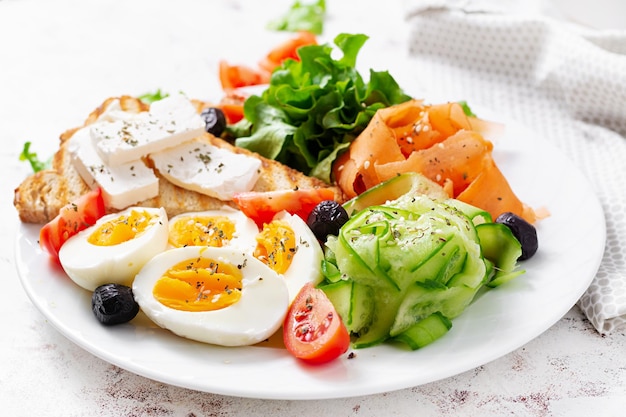 Healthy breakfast Salad with feta cheese eggs cucumber and carrot Healthy balanced food