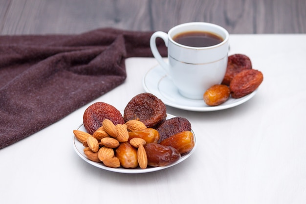 Healthy breakfast or snack concept. Black coffee, dried fruits. Copy space.