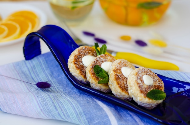 Healthy breakfast table with cheesecakes from cottage cheese 