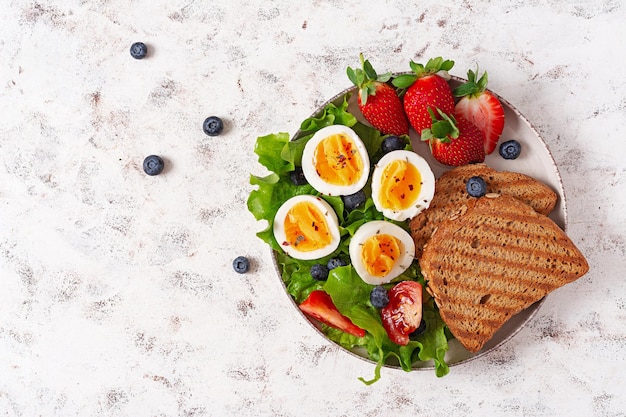 Healthy breakfast Toast with strawberry and egg Healthy balanced food Top view flat lay