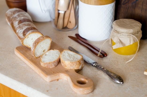 Healthy breakfast with baguette tomatoes on wooden board