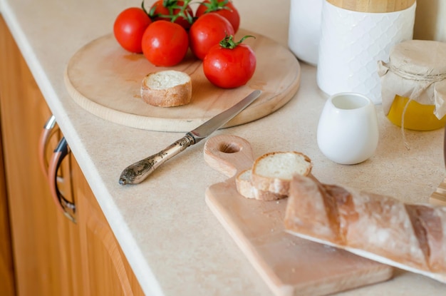 Healthy breakfast with baguette tomatoes on wooden board