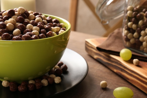 Healthy breakfast with corn balls and grapes on table