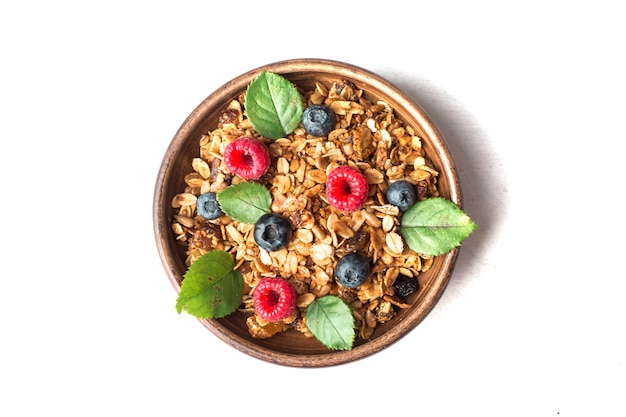 Healthy breakfast with granola and berries on white background