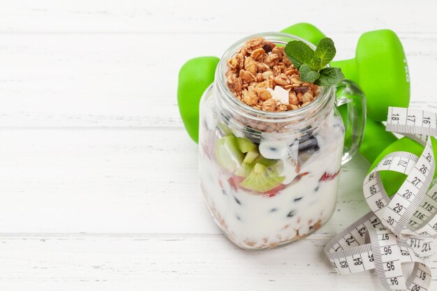 Healthy breakfast with jar of granola yogurt and fresh berries