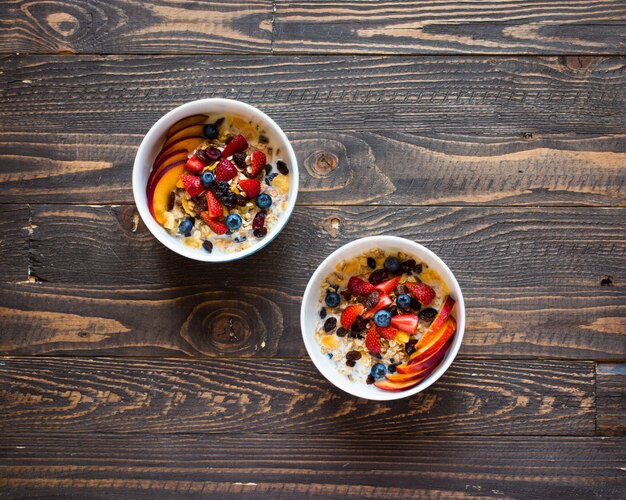 Healthy breakfast with milkmuesli and fruit on a wooden background.