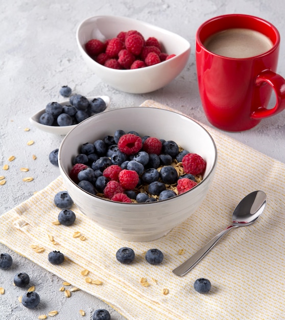 Healthy breakfast with oatmeal, coffee and berries.