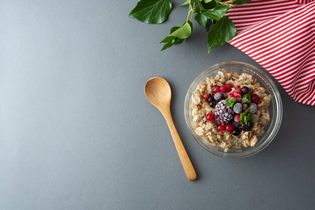 Healthy breakfast with oats, berries and mint. Overnight oat porridge with fruits.