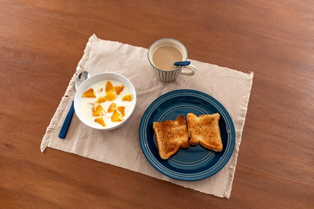 Healthy breakfast with orange coffee and toasts on wood