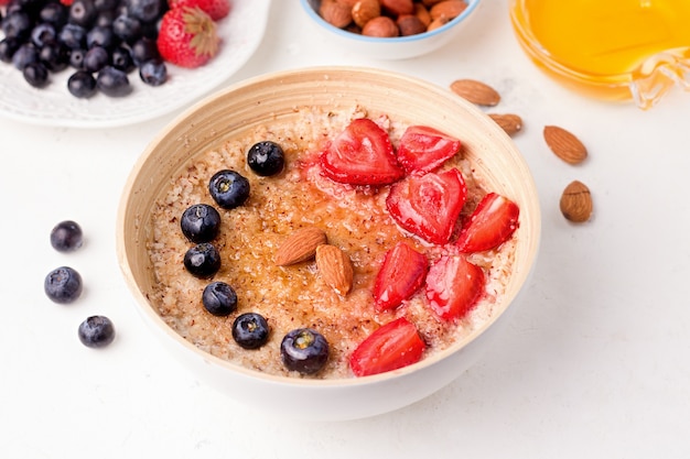 Healthy breakfast with porridge and berries in a bowl