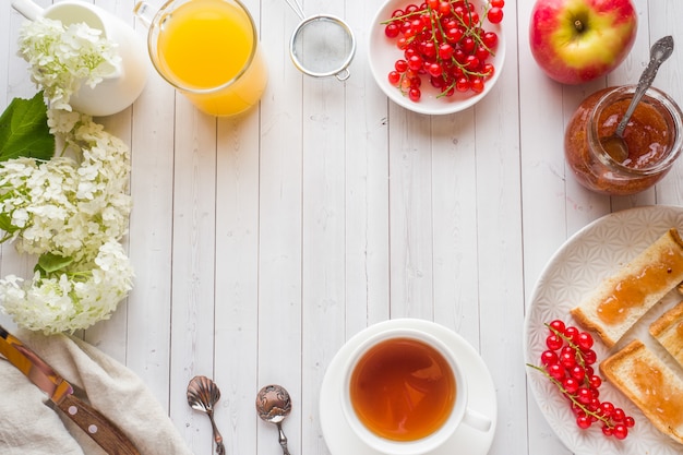 Healthy Breakfast with toast, jam, fresh orange juice and red currants