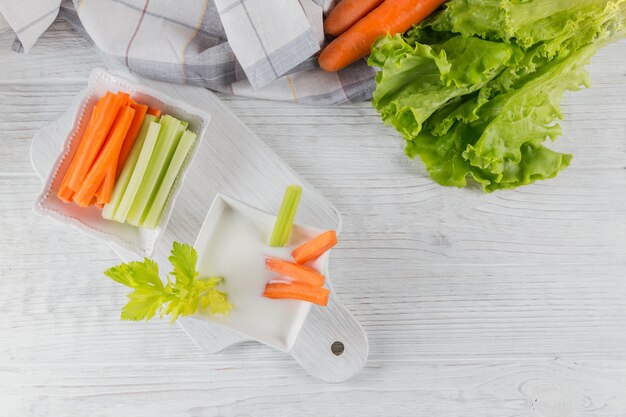 Healthy breakfast with yogurt celery and carrot sticks diet and healthy snack food