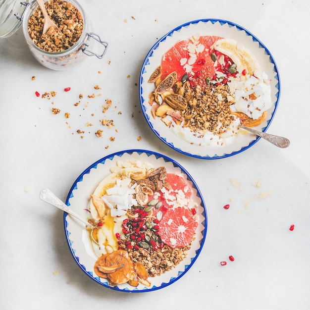 Healthy breakfast yogurt bowls with granola fruits seeds nuts
