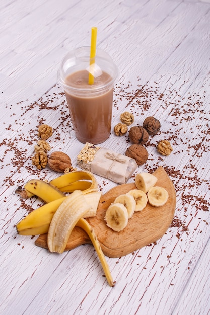 healthy brown smoothie with walnut and fruits lie on the table