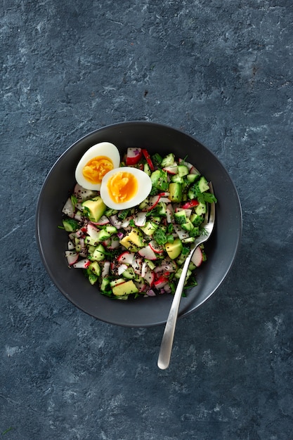 Healthy brunch salad with eggs top view