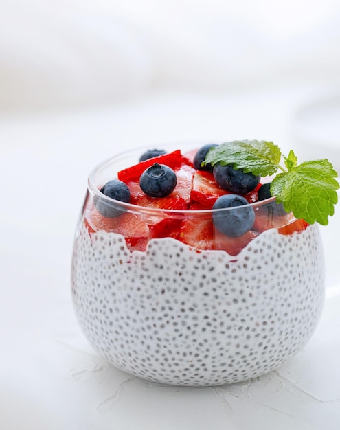 Healthy Chia Pudding with Coconut Milk strawberries chia seeds blueberries in a Glass