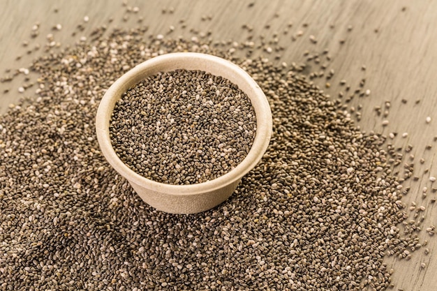 Healthy Chia seeds in a paper bowl close-up.