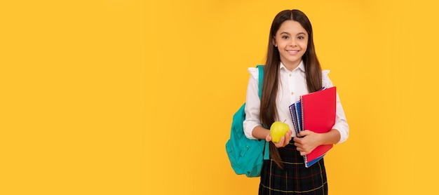 Healthy childhood happy kid going to do homework portrait of\
schoolgirl student studio banner header school child face\
copyspace