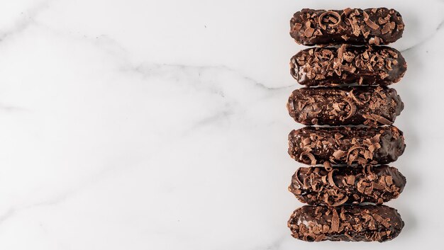 Healthy chocolate eclairs on marble background