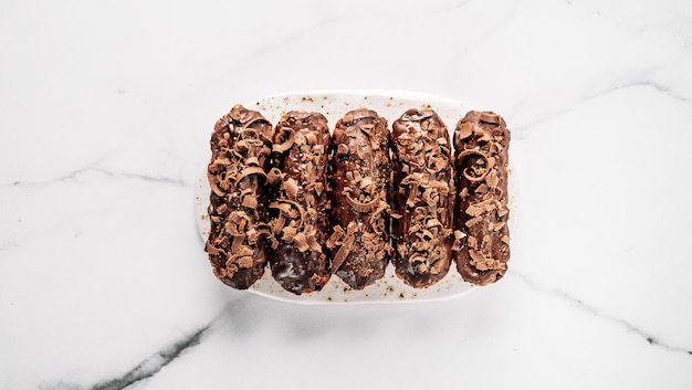 Healthy chocolate eclairs on marble background