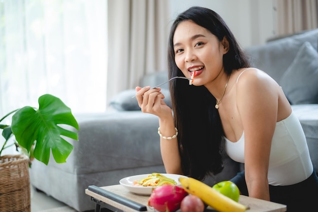 Photo healthy clean food concept asian woman with fresh vegetable for diet lifestyle happy vegetarian