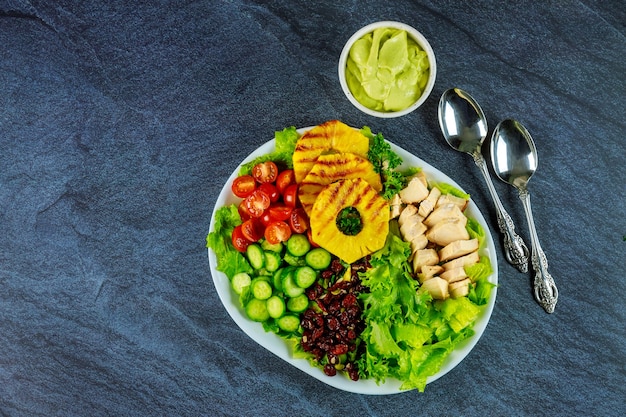 Healthy colorful salad with vegetable, boiled eggs and chicken breast.