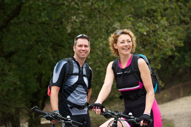 Healthy couple smiling with bicycles 