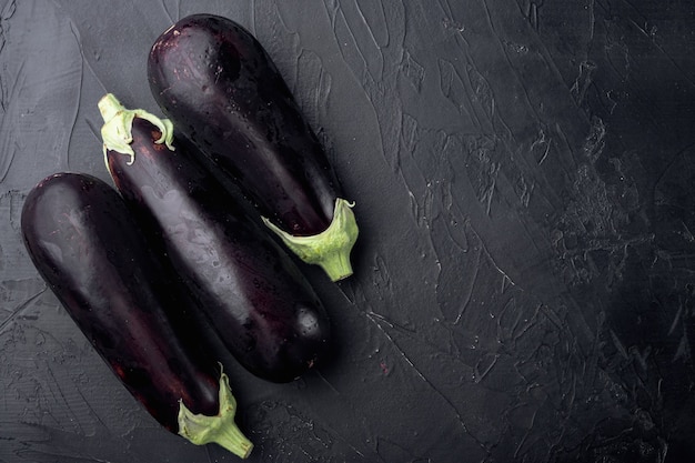 Healthy and delicious purple eggplants set, on black stone