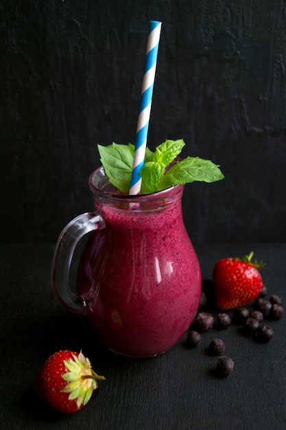 Healthy delicious smoothie of blueberries. on a black background.