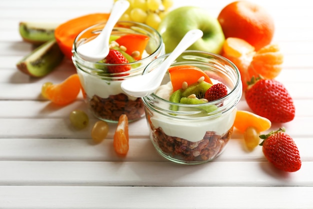 Healthy dessert with muesli and fruits on table