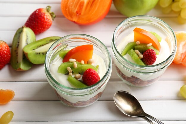 Healthy dessert with muesli and fruits on table