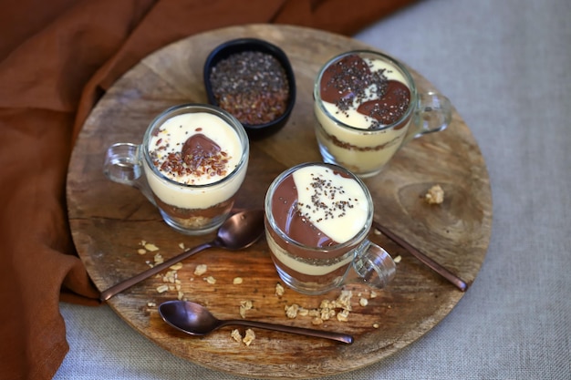 Healthy desserts in mugs Vanilla and chocolate puddings with chia seeds and linseeds