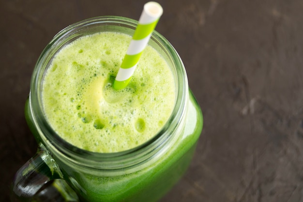 Healthy detox green smoothie in a mason jar.