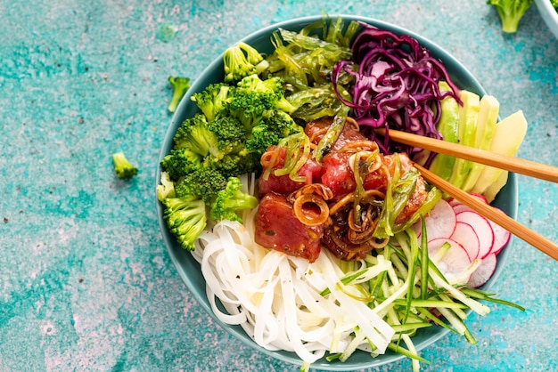 Healthy Diet Bowl Raw Tuna Fish with Rice Noodles and Vegetables Arranged in Decorative Bowl