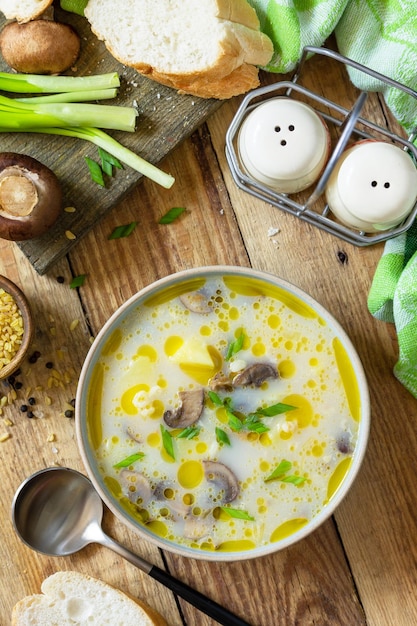 Healthy and diet eating concept Mushroom cream soup with bulgur and cream Top view flat lay