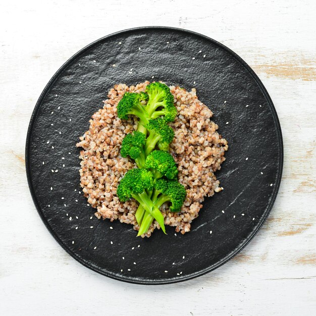 Healthy Diet Food Boiled buckwheat and broccoli On a black stone plate Top view