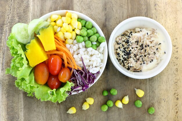 healthy and diet food , fresh vegetable salad with tuna cream salad on wood table