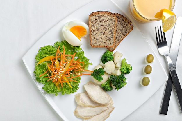 Healthy diet meal with boiled chicken meat, broccoli and vegetables salad