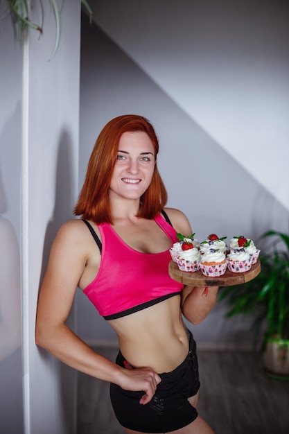 Healthy Diet And Nutrition Portrait of happy beautiful young woman eating natural cake at home and looking at cameraWeight Loss Food Concept I baked with for you with love