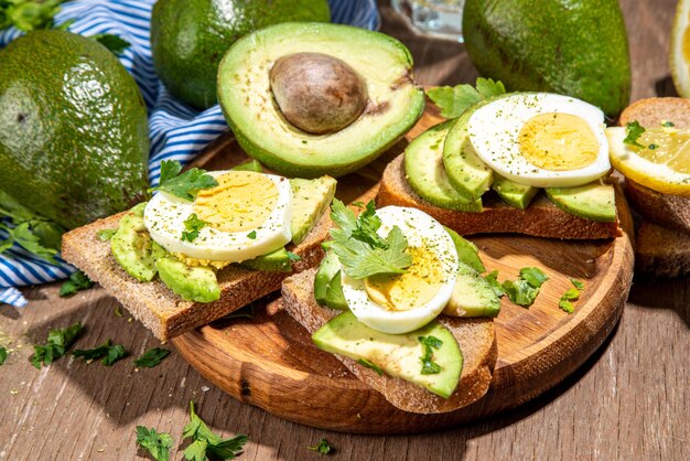 Healthy diet sandwiches for breakfast snack toast with\
guacamole avocado salsa and boiled egg