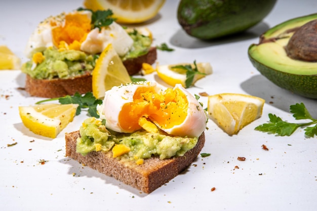 Healthy diet sandwiches for breakfast snack Toast with guacamole avocado salsa and poached egg