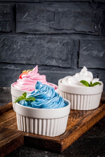 Healthy diet summer dessert, vanilla and berry frozen yogurt or  soft ice cream in white bowls