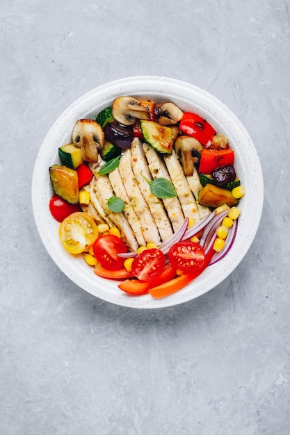 Healthy dinner buddha bowl lunch with chicken quinoa grilled and fresh vegetables Top view