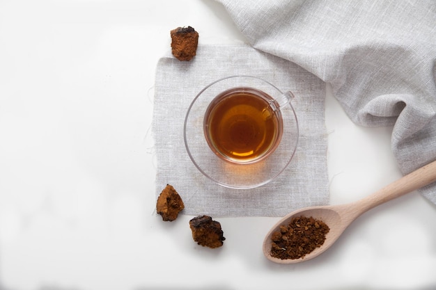 Healthy drink coffee from chaga mushroom in a glass cup on a white background Top view Copt spaes