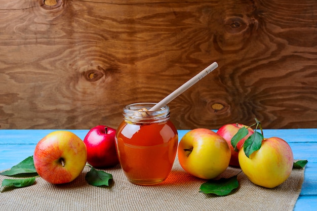 healthy eating concept with glass honey jar and fresh apples, copy space 