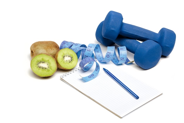 Healthy eating, diet and weight loss, detox . dumbbells, kiwi and measuring tape