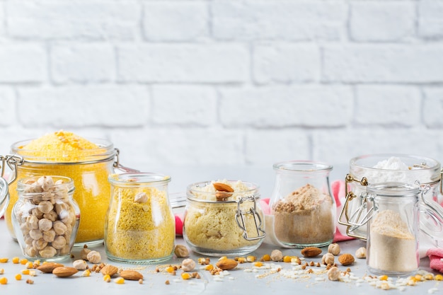 Healthy eating, dieting, balanced food concept. Assortment of gluten free flour, almond, corn, rice on a kitchen table. Copy space background