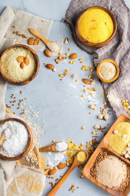 Healthy eating, dieting, balanced food concept. Assortment of gluten free flour, almond, corn, rice on a table. Top view flat lay background