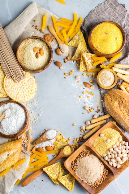 Healthy eating, dieting, balanced food concept. Assortment of gluten free food and flour, almond, corn, rice on a table. Top view flat lay background
